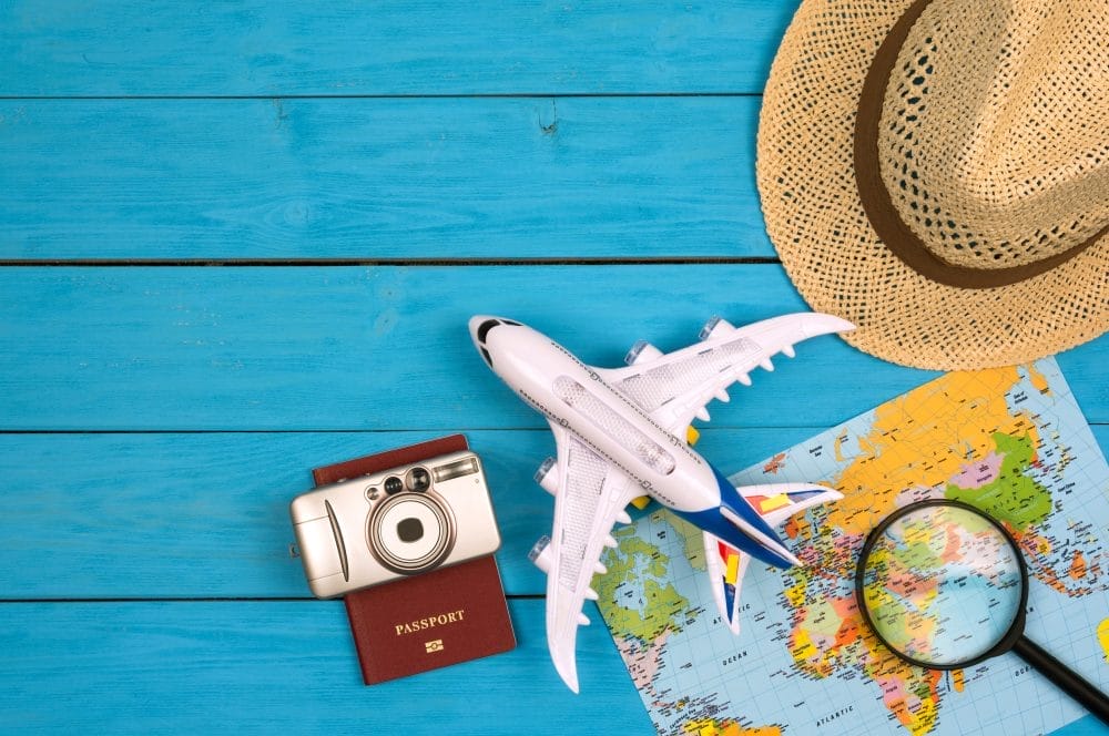 A toy plane, hat, and passport on a map