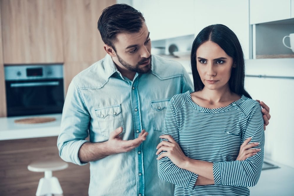 Man attempting to speak to his quiet girlfriend