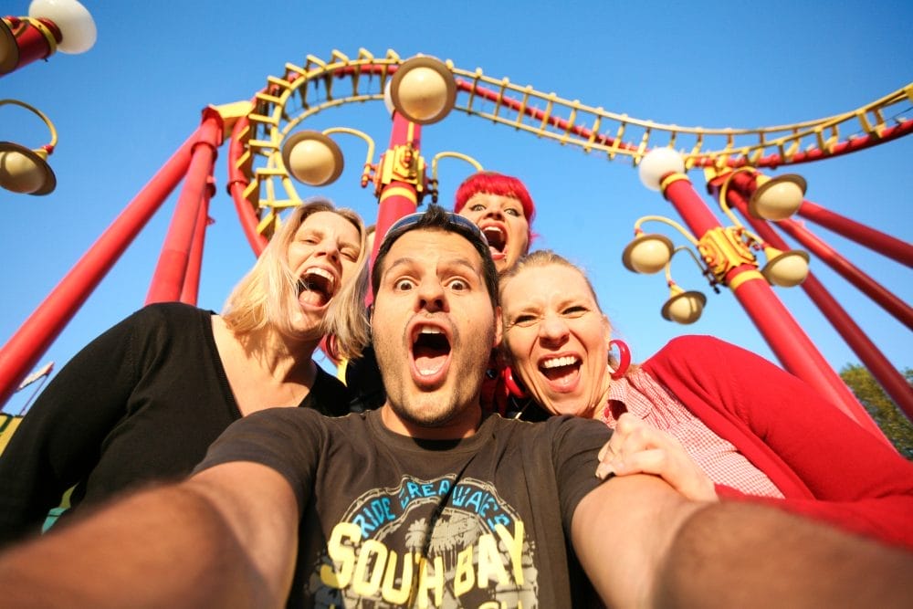 A family taking a selfie at a theme park