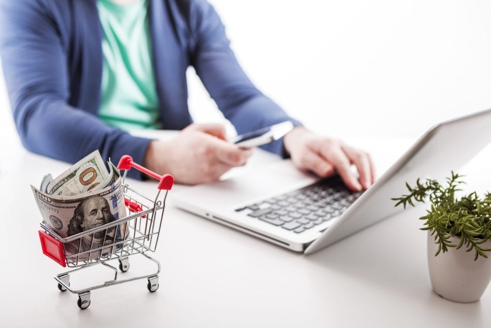 A man shopping with his credit card on a laptop