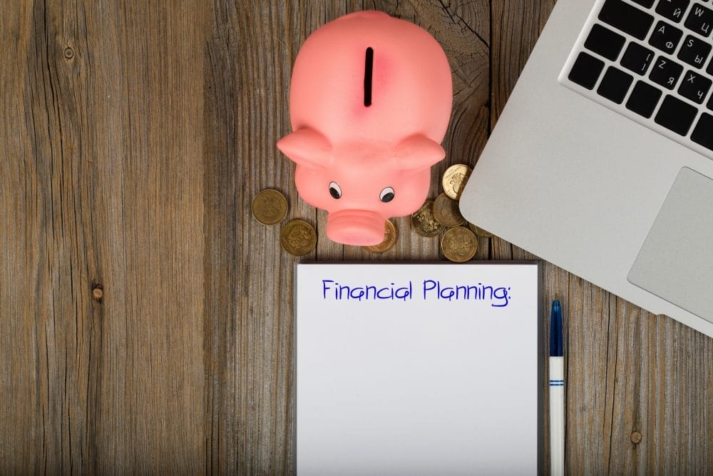 A piggy bank with a paper that says "financial planning"