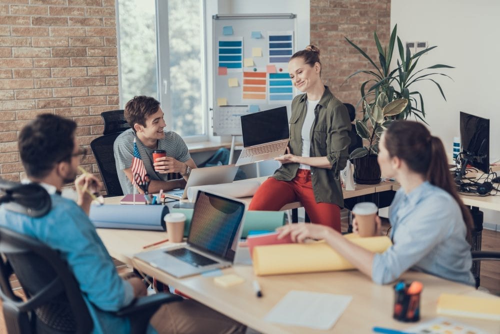 A work meeting with a woman holding a laptop