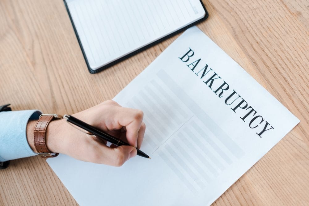 Someone signing bankruptcy paperwork