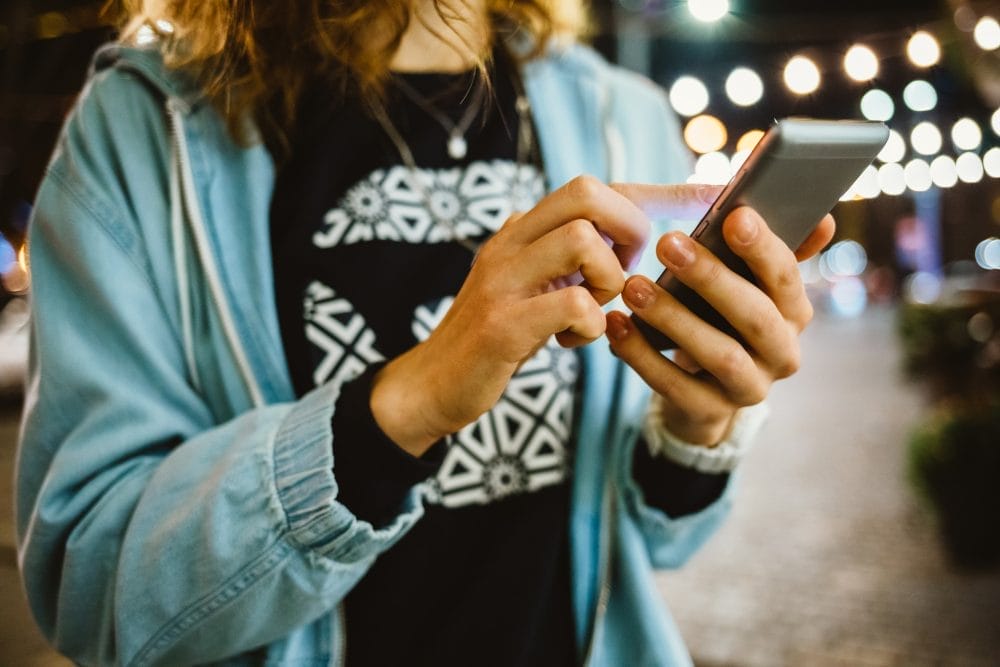 Woman typing on a phone