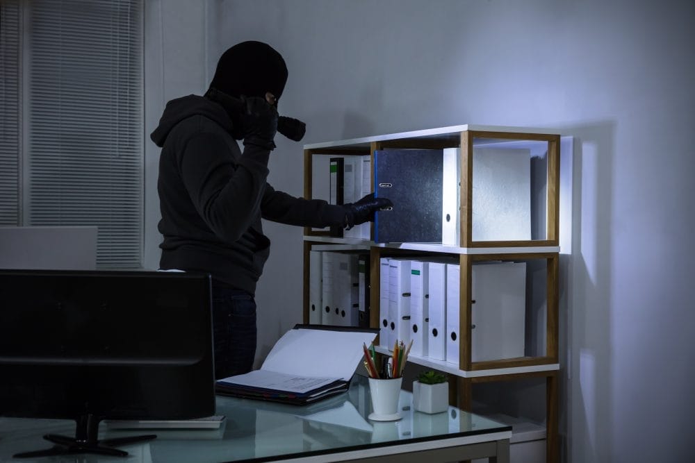 thief going through a filing cabinet