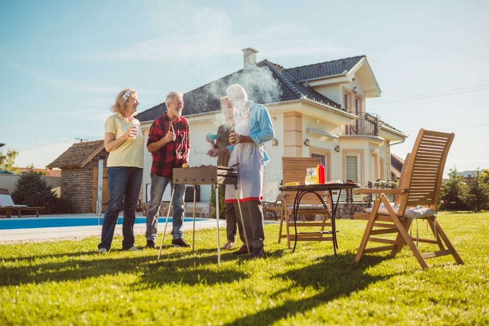 A group of neighbors having a backyard barbecue