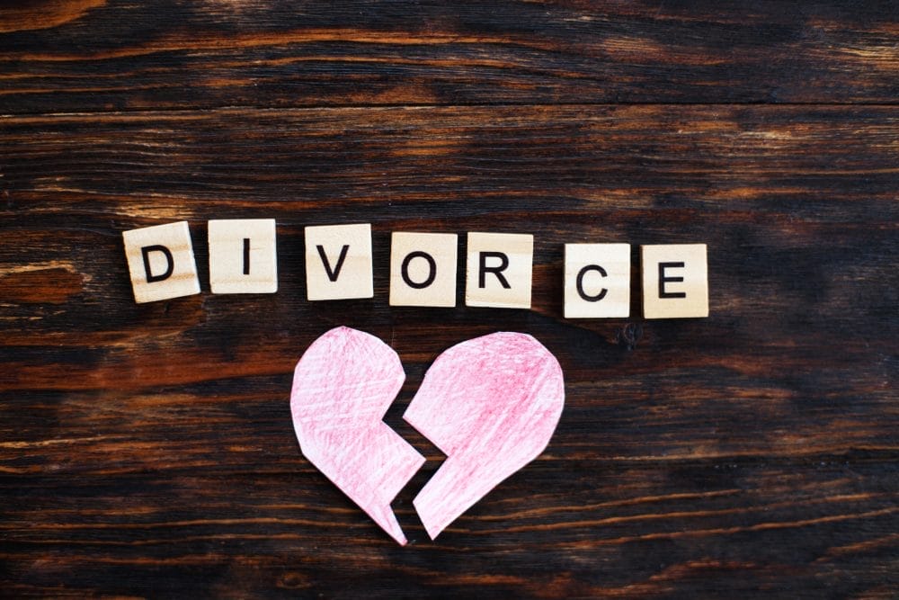 A ripped paper heart with the word "divorce" written out in blocks