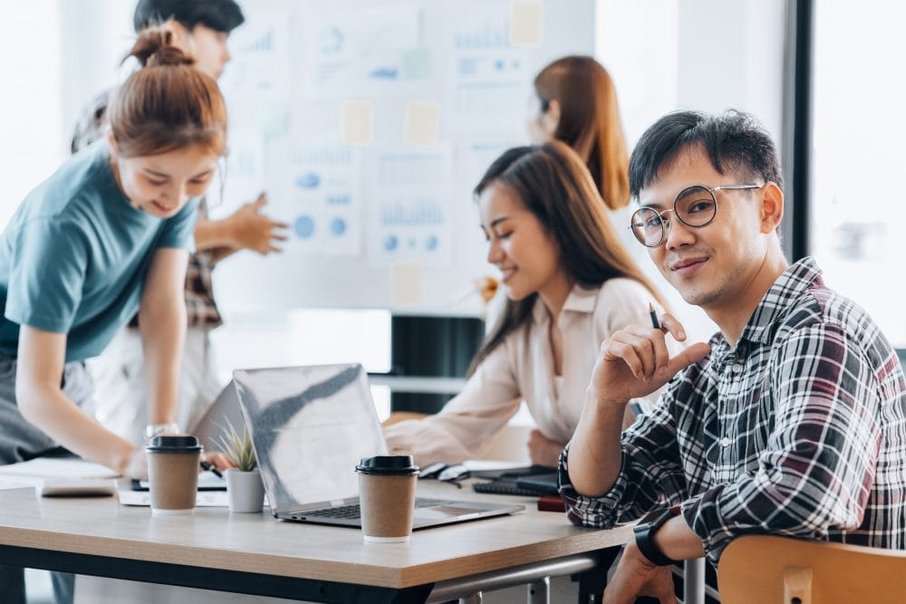 Gen Z workers at an office on computers 