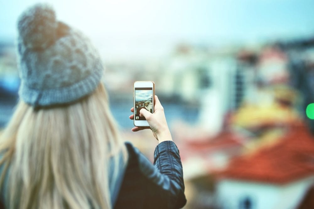 woman looking at her smartphone outside