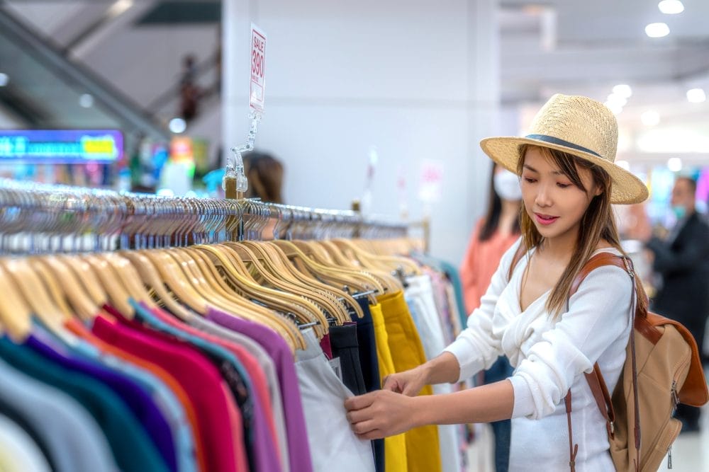 A woman shopping for clothing in a department store