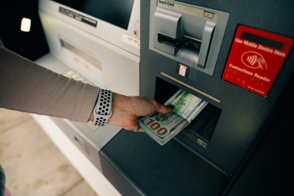 woman taking money from an ATM