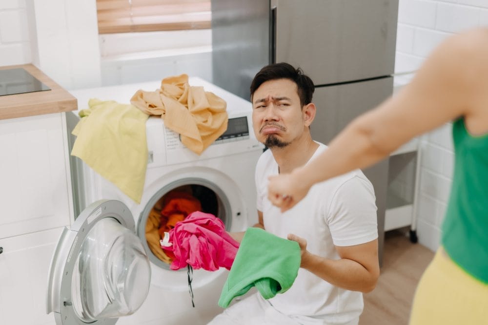 frowning man doing laundry