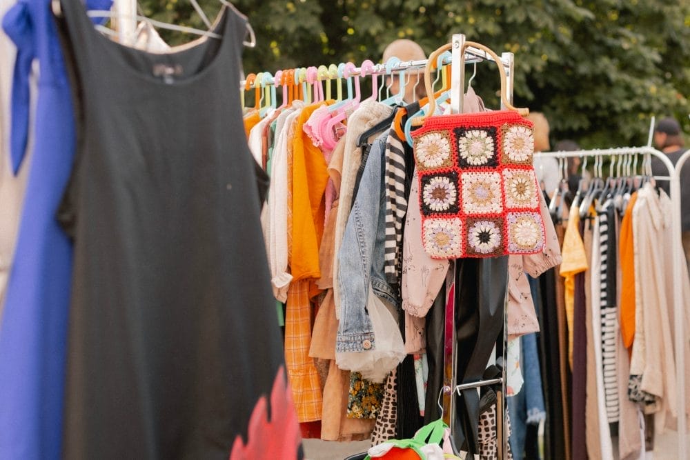 Racks of clothing at a yard sale