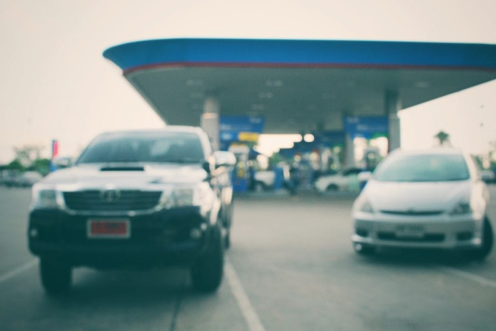 A couple of cars at a gas station
