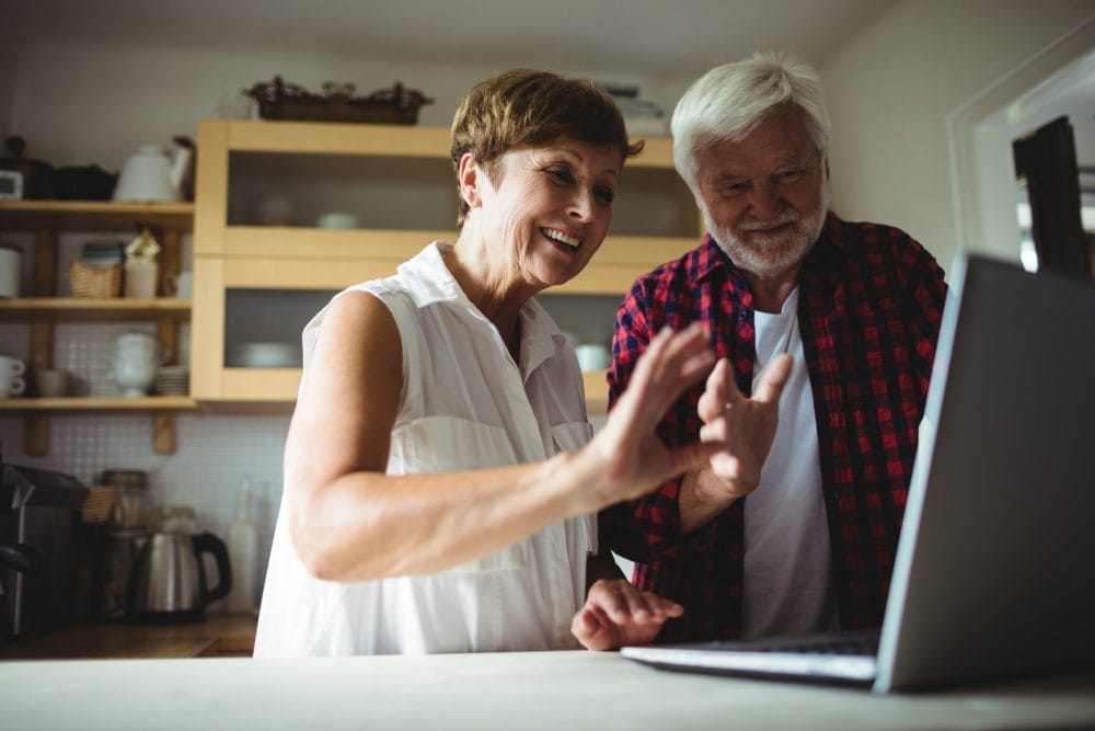 A pair of baby boomers using a laptop
