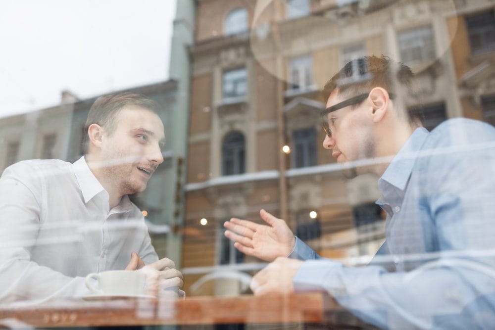two men having conversation together