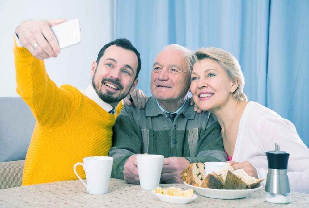 Adult son taking a selfie with his parents