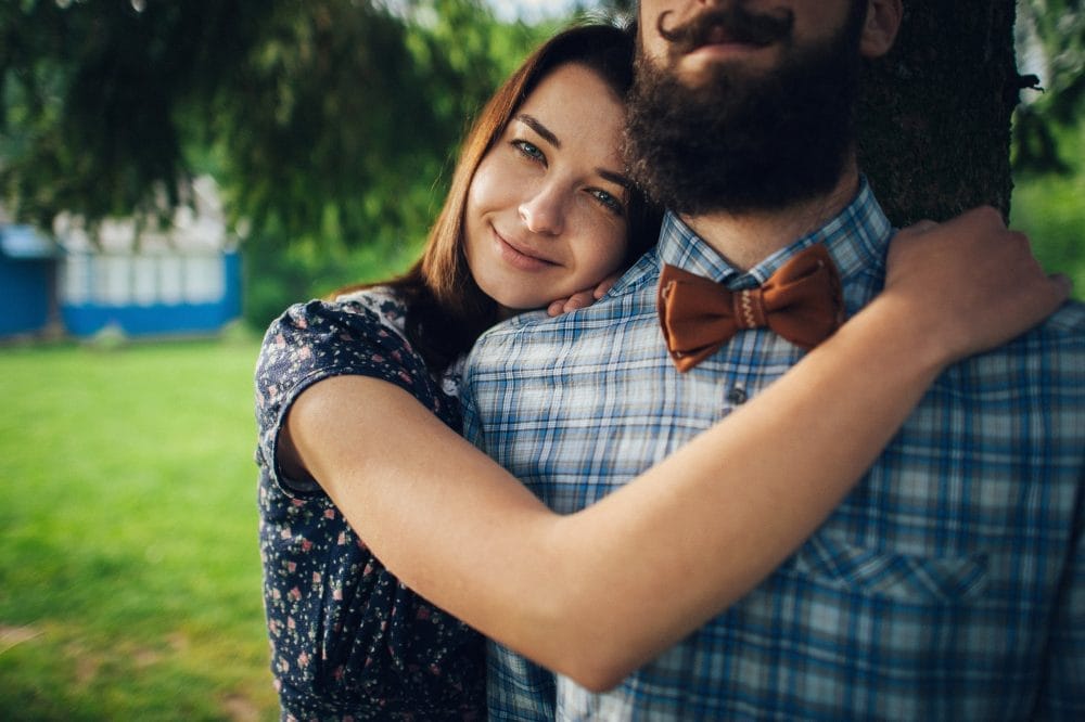 smiling woman hugging her boyfriend