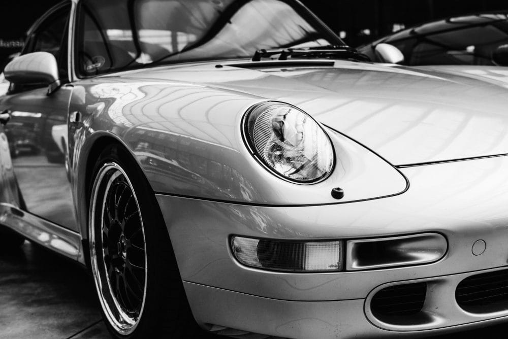 closeup of the headlights and front bumper on vintage automobile