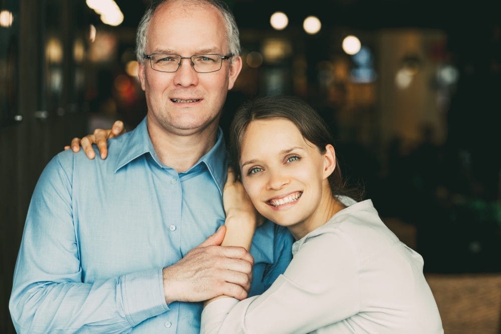 Smiling adult daughter with his father