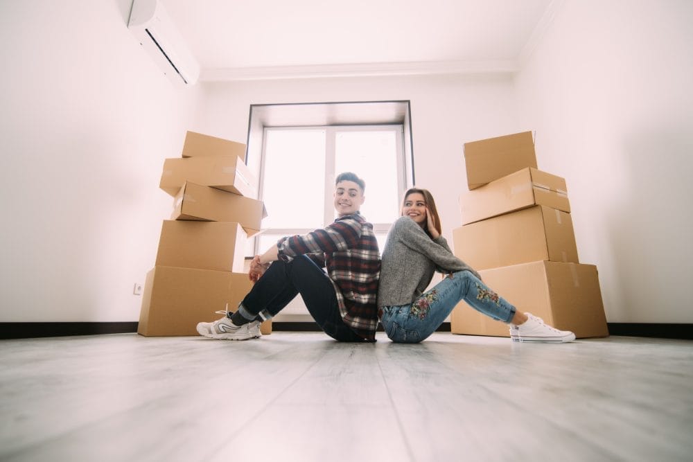 A couple moving into a small apartment with moving boxes
