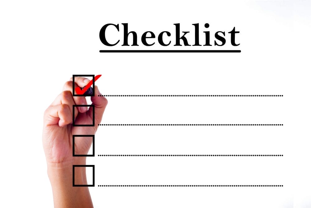 Businessman hand checking mark on checklist with marker over white.