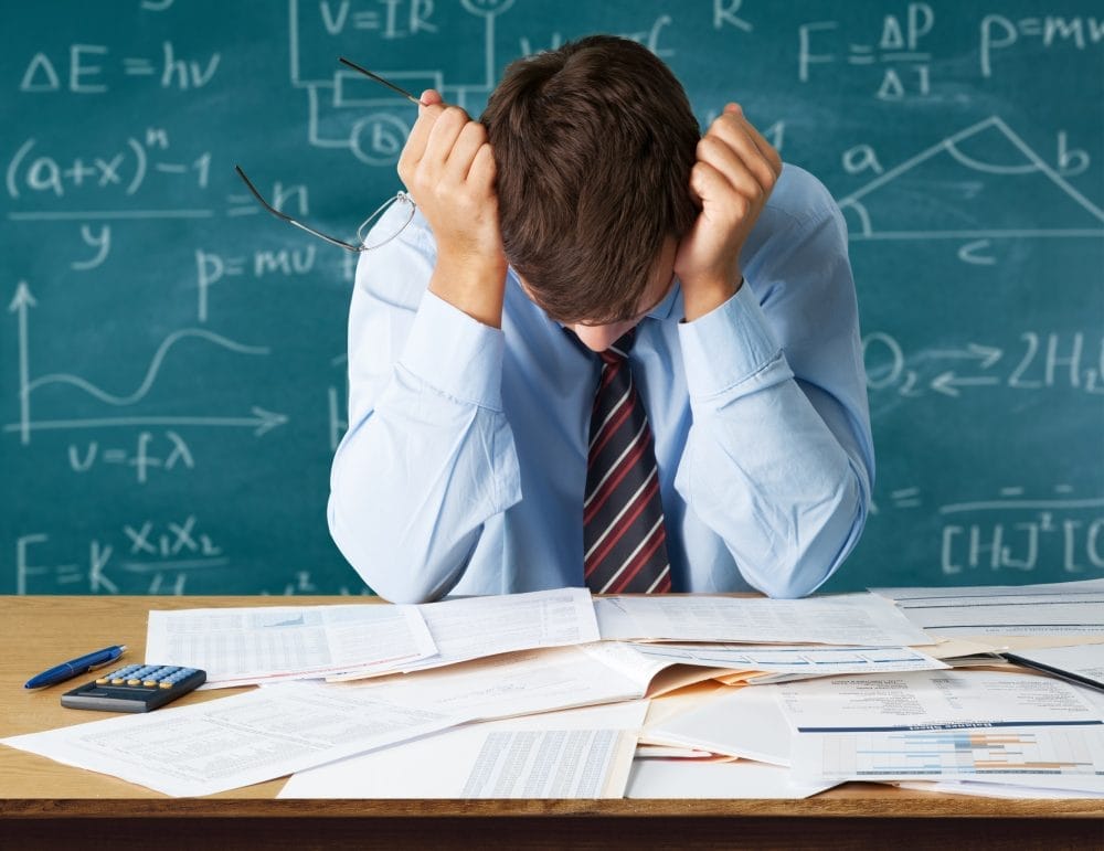A tired teacher at his desk