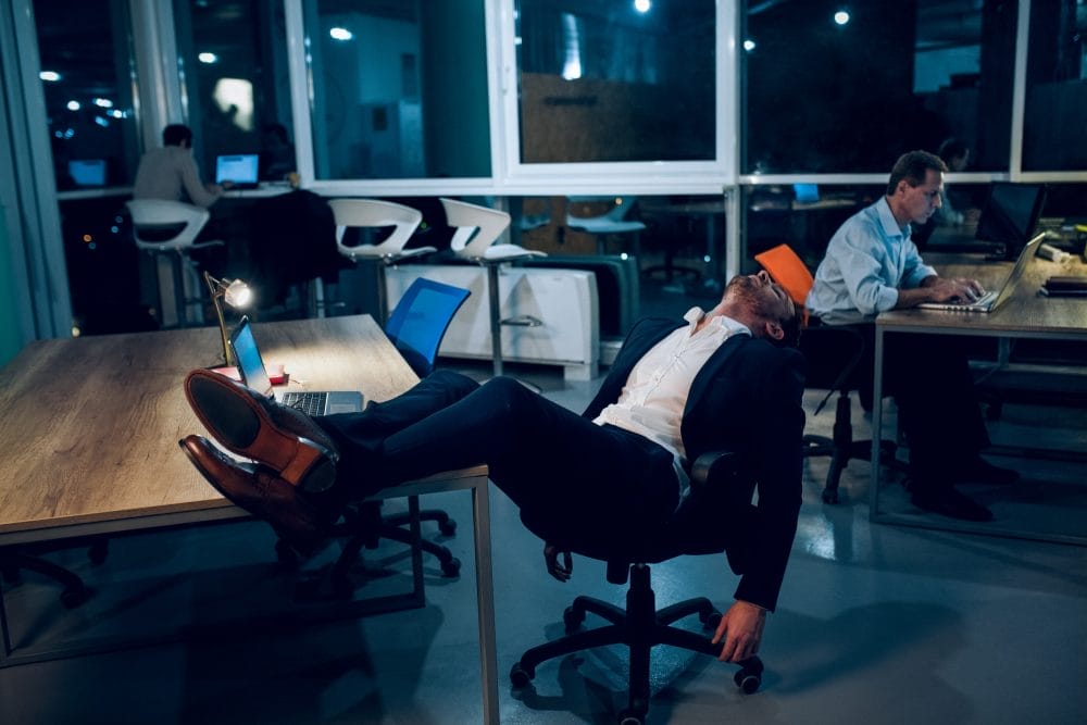 Businessman falling asleep during work.