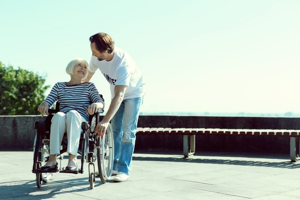 Volunteer helping an elderly patient in a wheelchair