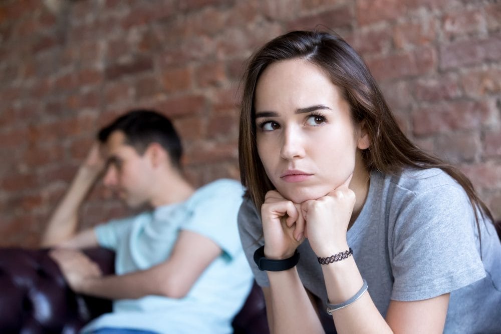 A couple that doesn't trust one another, looking upset and distant