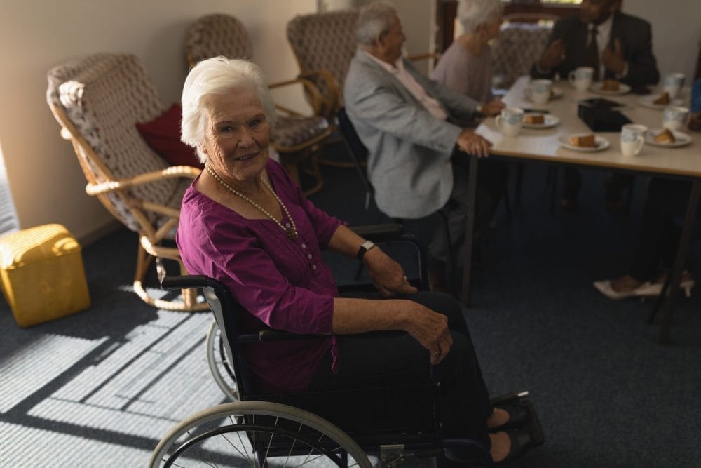 An older woman in a wheelchair in a nursing home