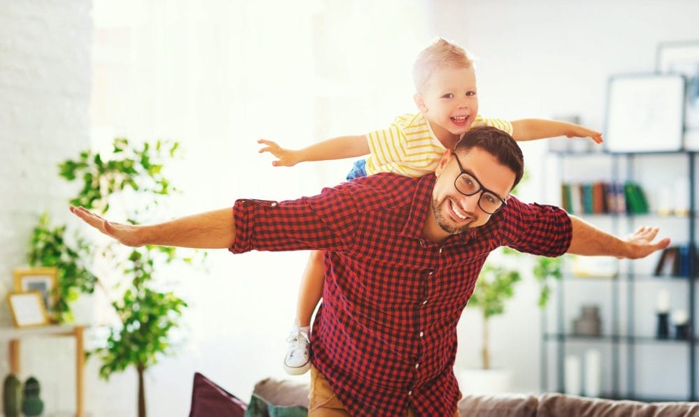A stay-at-home dad at his house with his son
