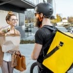 A courier working for a food delivery app, that is ruining our relationship with cooking.