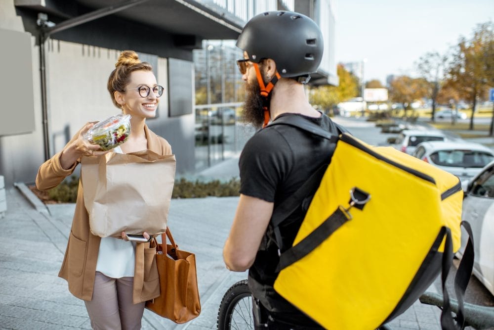 A courier working for a food delivery app, that is ruining our relationship with cooking.