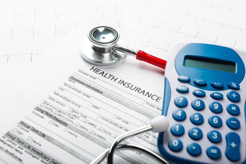 A calculator and health insurance form