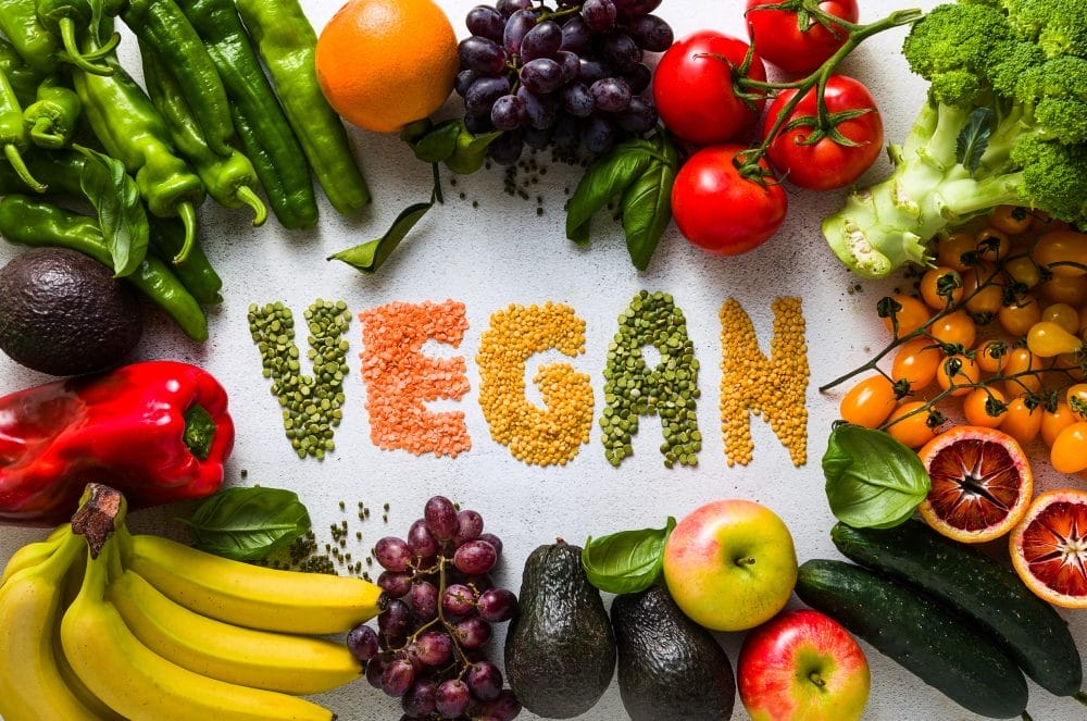 The word "vegan" written out in vegetables
