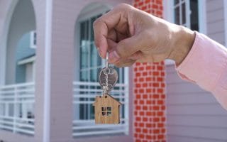 Landlord handing over the house key for new home