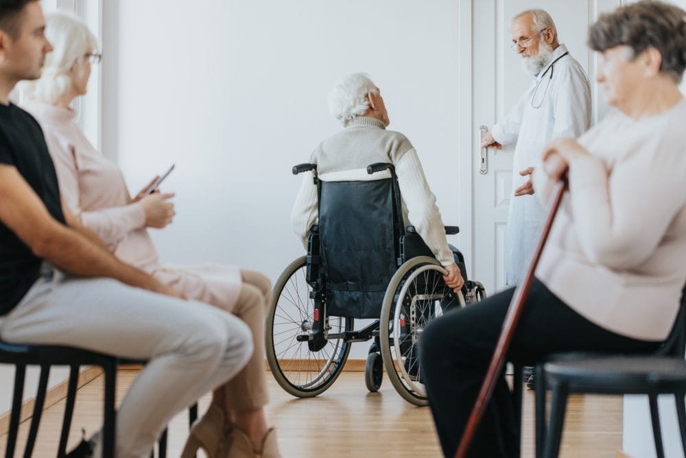 An older man in a wheelchair at a nursing home