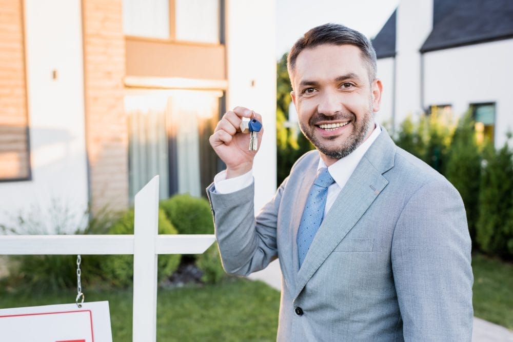 A happy real estate agent with a key