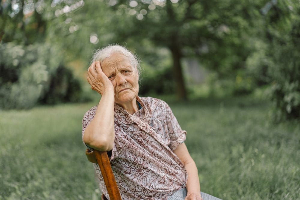 An elderly person experiencing loneliness in a retirement community