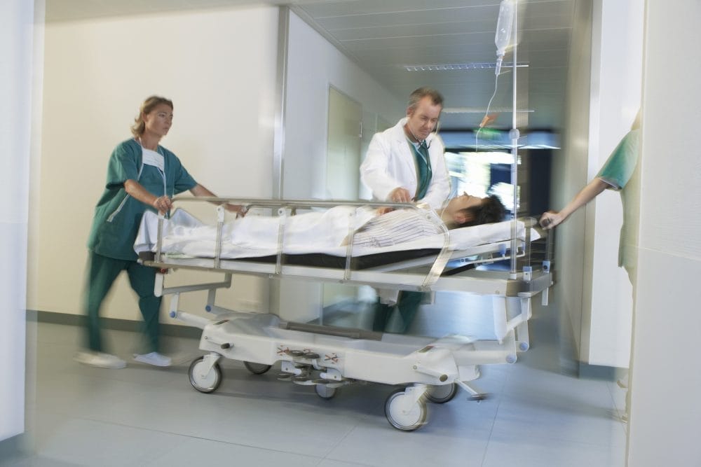 Doctors With Patient on Stretcher in the emergency room