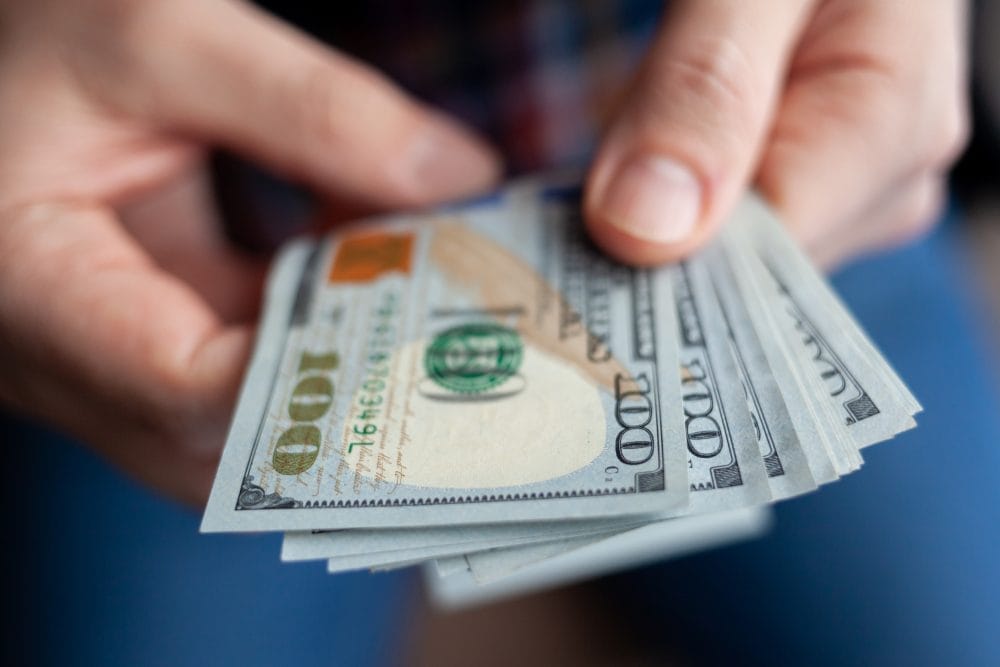 Close up of male hands counting money