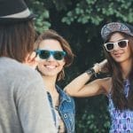 Two young woman communicate with a man