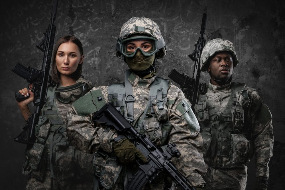 Squad of three soldiers against grey background