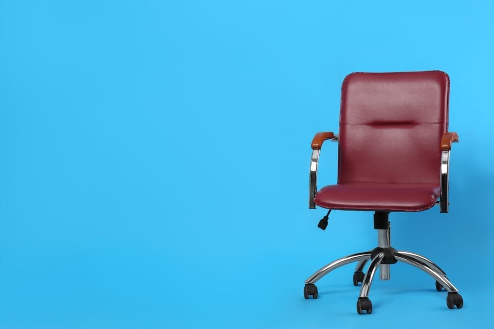 Cheap furniture: an older office chair on a blue background