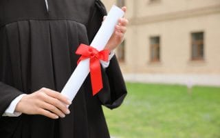 Student with diploma after graduation ceremony