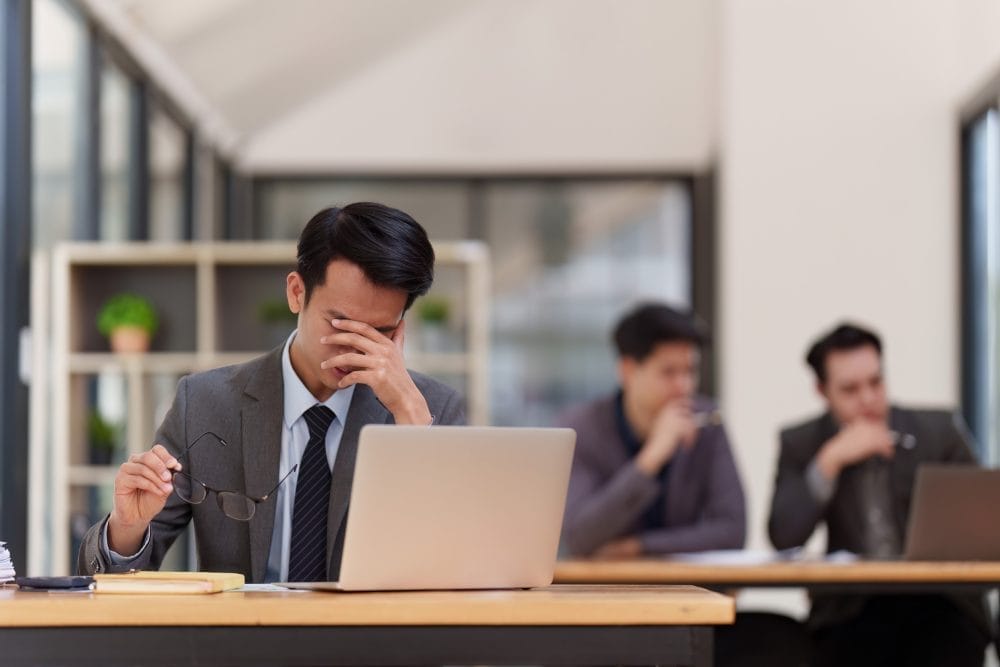 A distressed man at his desk after quiet firing