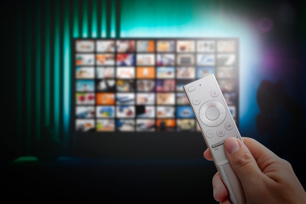 A man watching a streaming service on TV behind a paywall