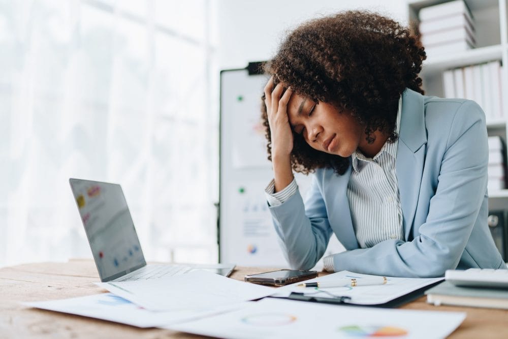 A young female profesional is tired and burnt out from work