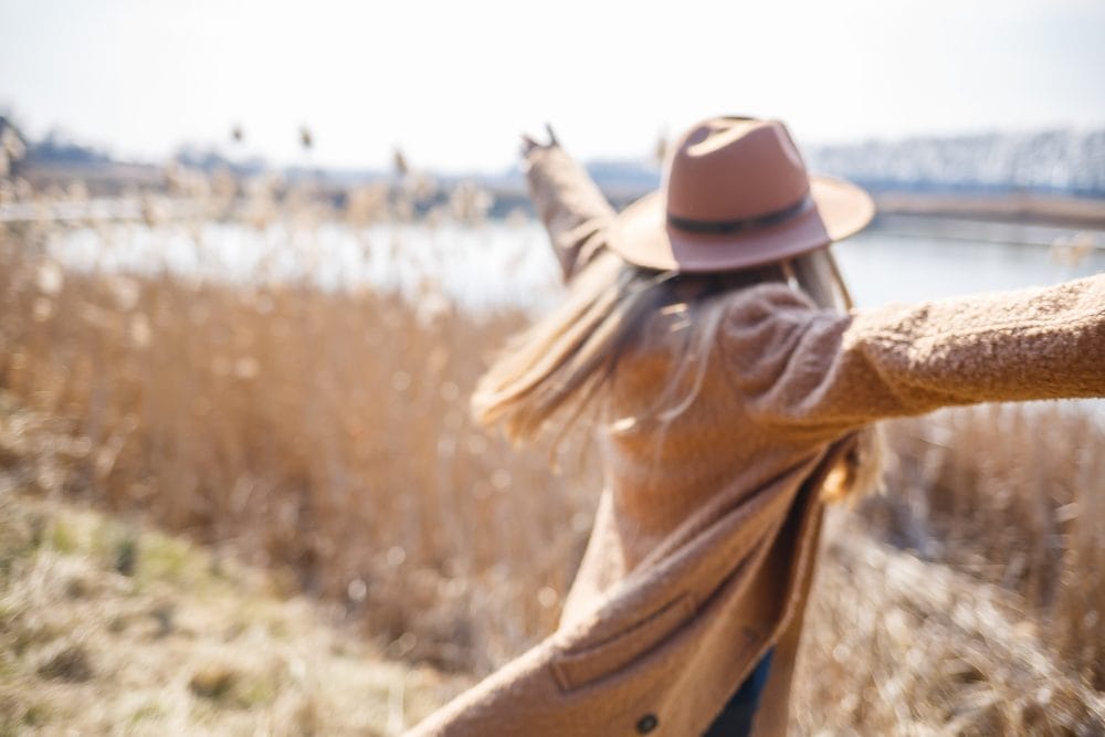 A woman who is outside and disengaging from the ugly comments online that hurt self-esteem